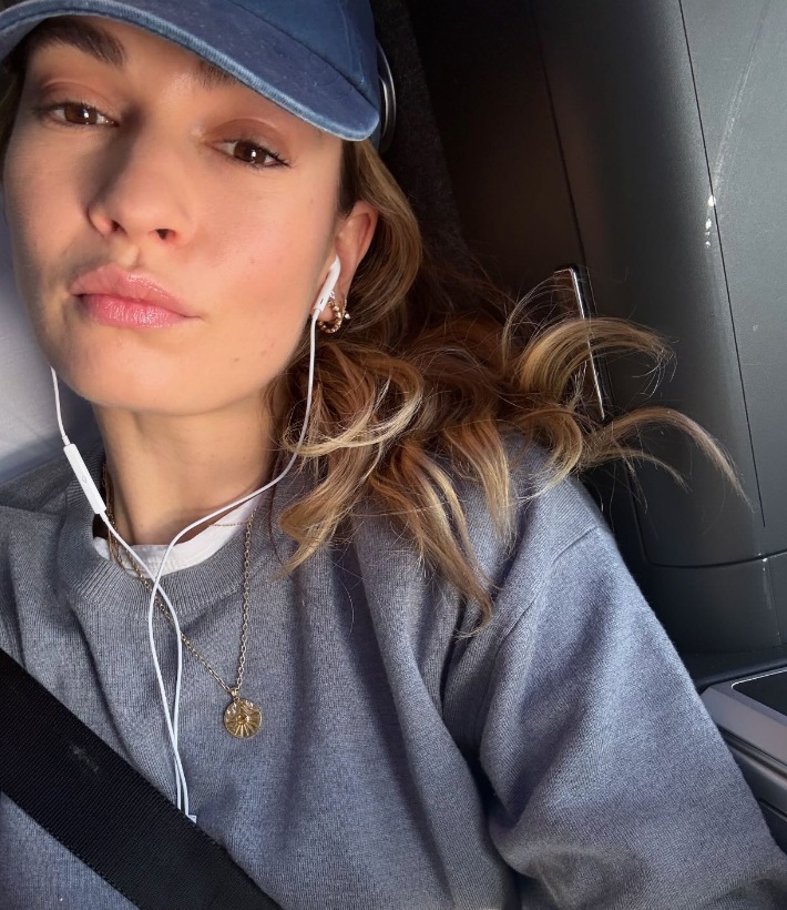 lily james wearing old-school wired headphones