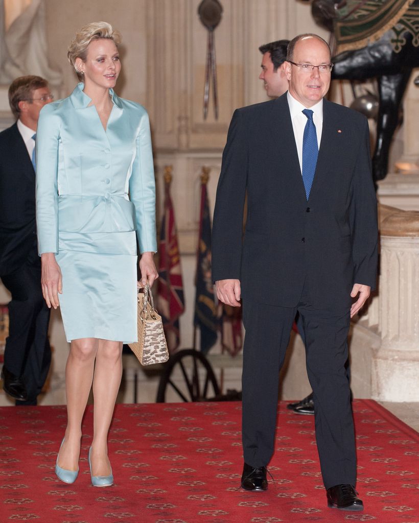 Princess Charlene in aqua blue ensemble and Prince Albert II in suit