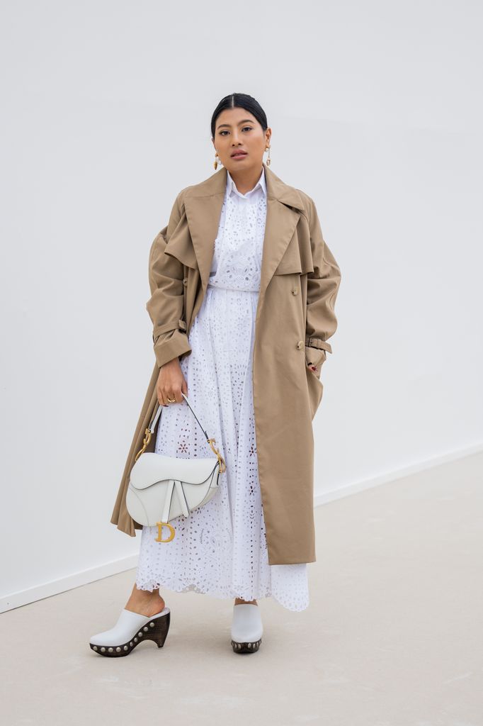  Princess of Thailand Sirivannavari Nariratana Rajakanya wears beige coat, white laced skirt and button shirt, bag outside Dior during Paris Fashion Week