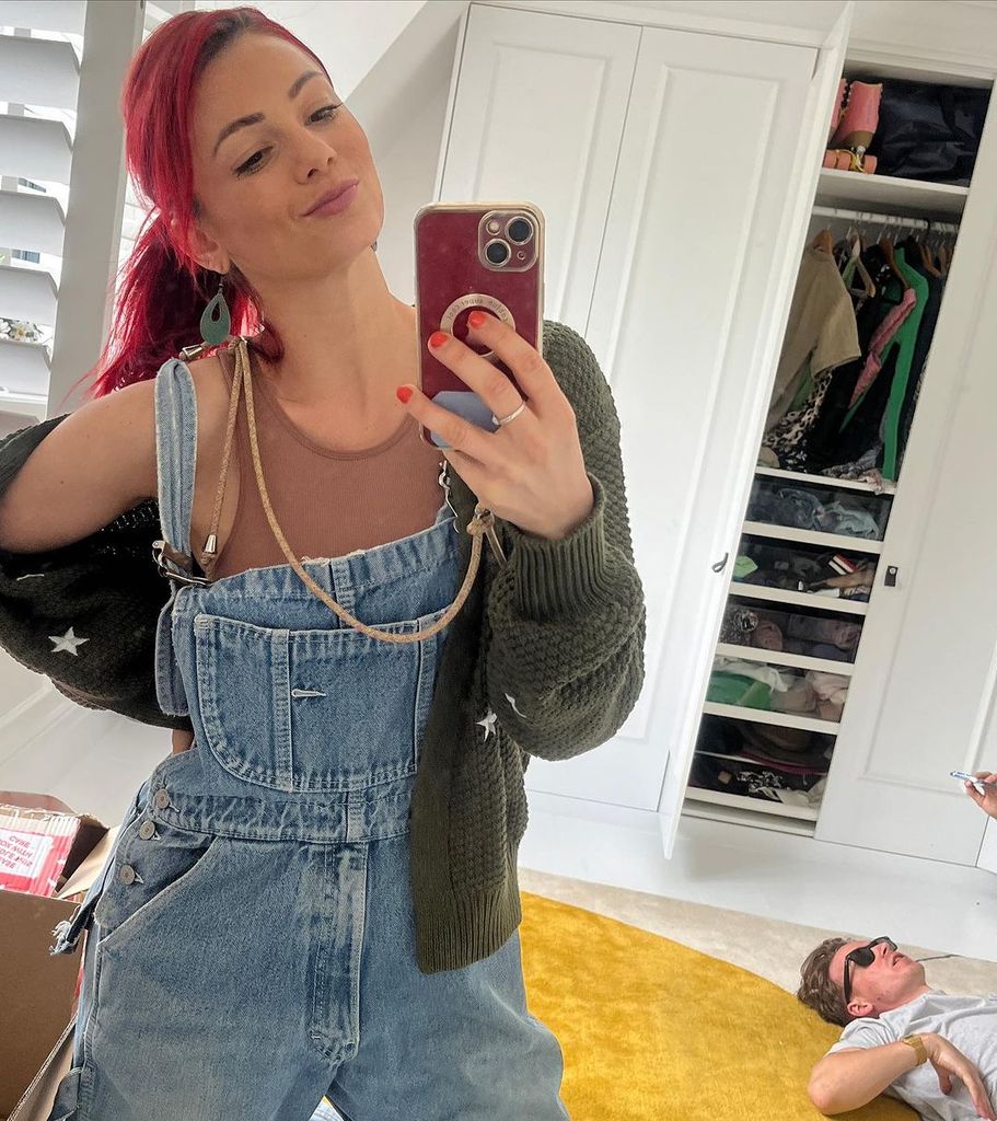 Dianne posing for a selfie with her wardrobe 