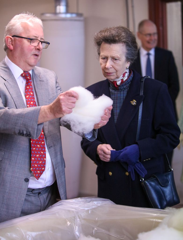 Anne inspecting wool at textile factory