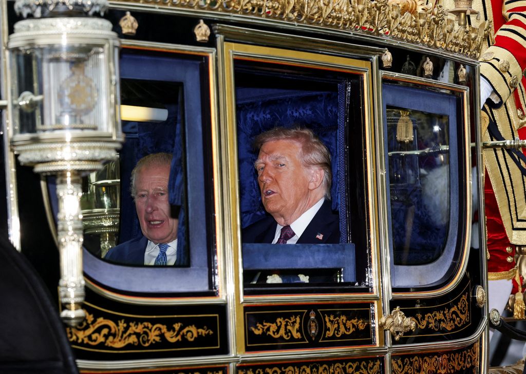 Britain's King Charles III and US President Donald Trump travel in The Irish State Coach during a horse-drawn procession towards Windsor Castle, in Windsor, on September 17, 2025