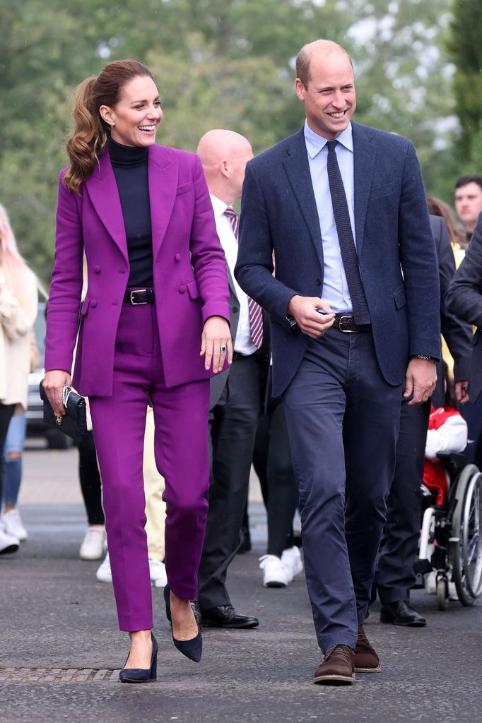 Kate in purple suit walking beside william