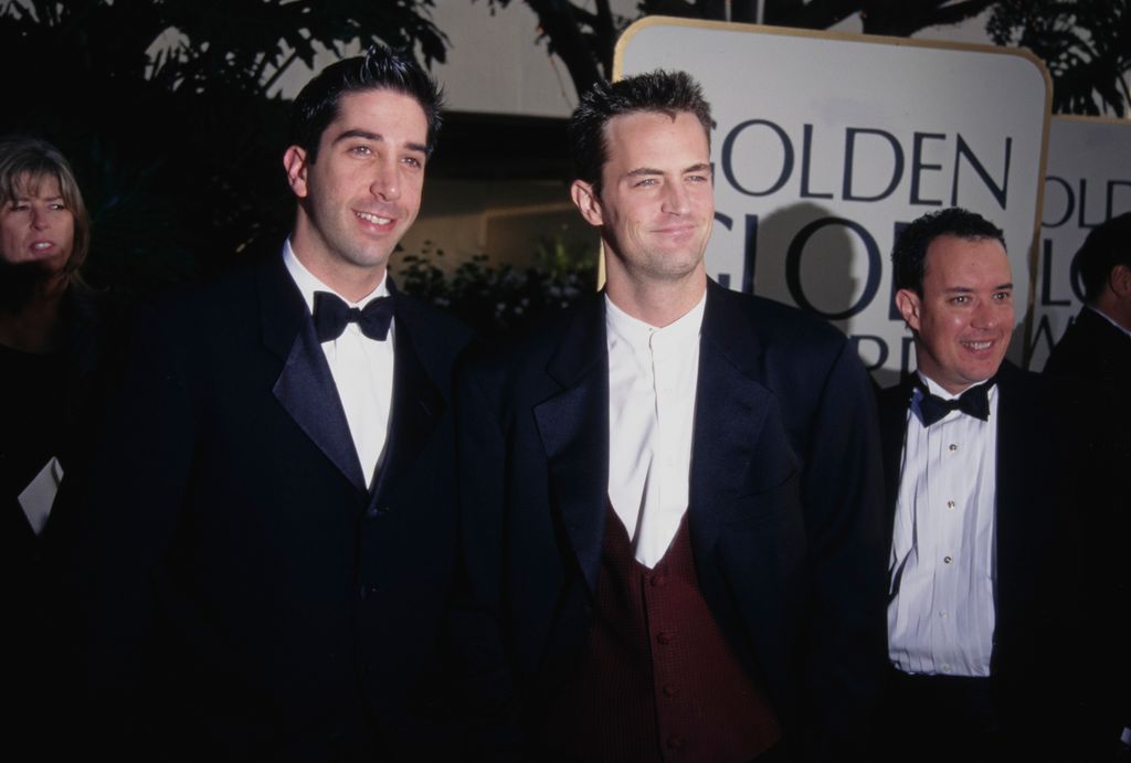 American actor David Schwimmer and Canadian-American actor Matthew Perry attend the 54th Golden Globe Awards, held at the Beverly Hilton Hotel in Beverly Hills, California, 19th January 1997. The man to the right of the frame is