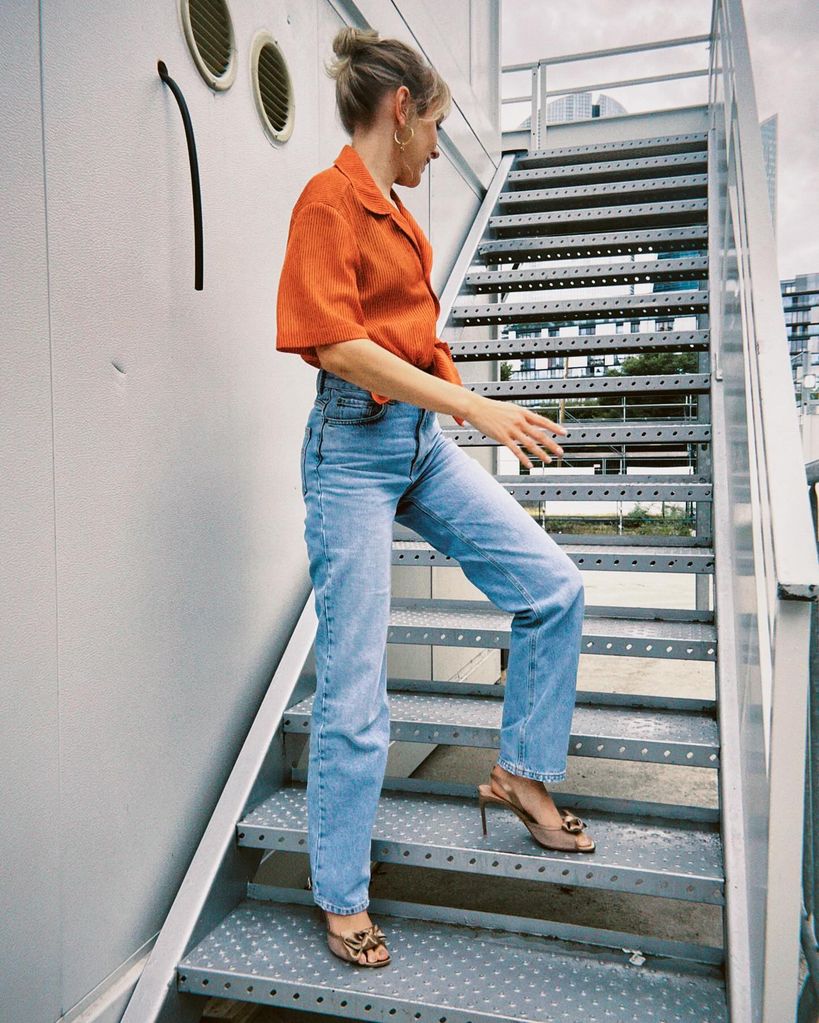 Rose Ayling-Ellis wearing high waisted jeans and orange top during Paralympics coverage 