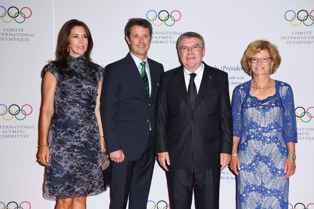 Queen Mary and King Frederik standing with Thomas and Claudia Bach at an Olympic event