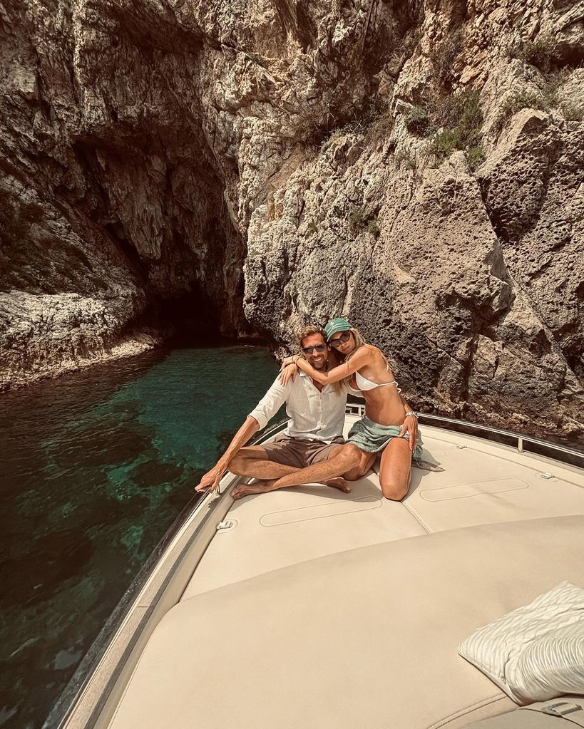 Abbey Clancy wearing white bikini on prow of boat with Peter Crouch