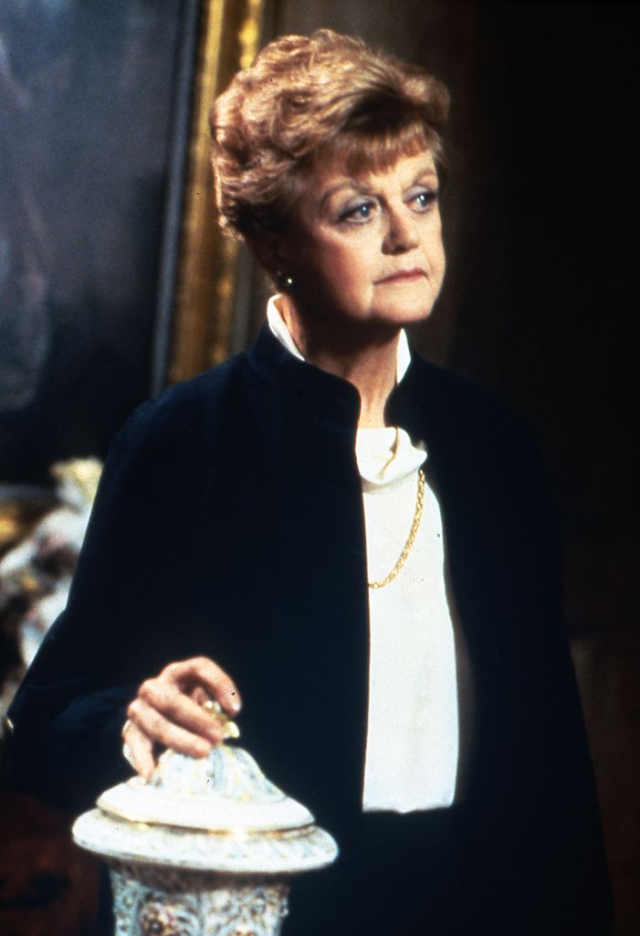 Angela Lansbury in Murder, She Wrote with her hand on an urn