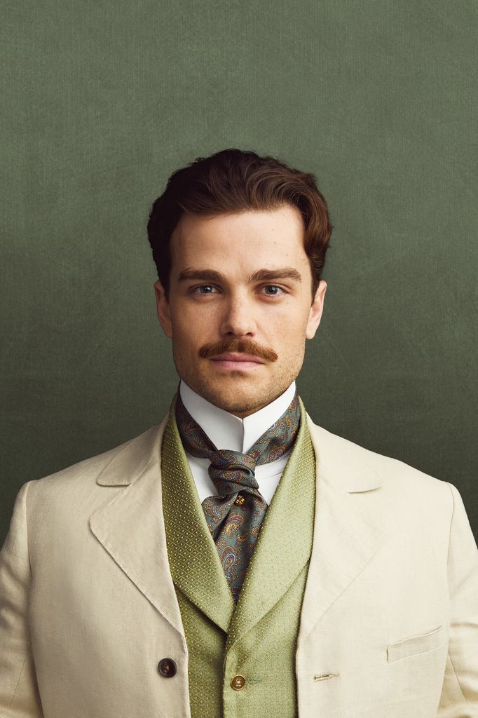 man in white suit against green background