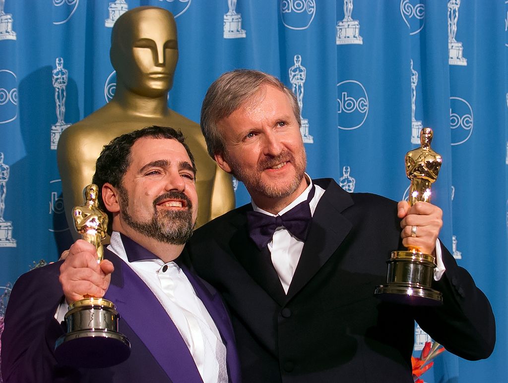 Oscar Winners Producer Jon Landau and Director James Cameron backstage with the Oscar Award for Best Picture 'Titanic' at Academy Awards Show, March 23, 1998 in Los Angeles, California