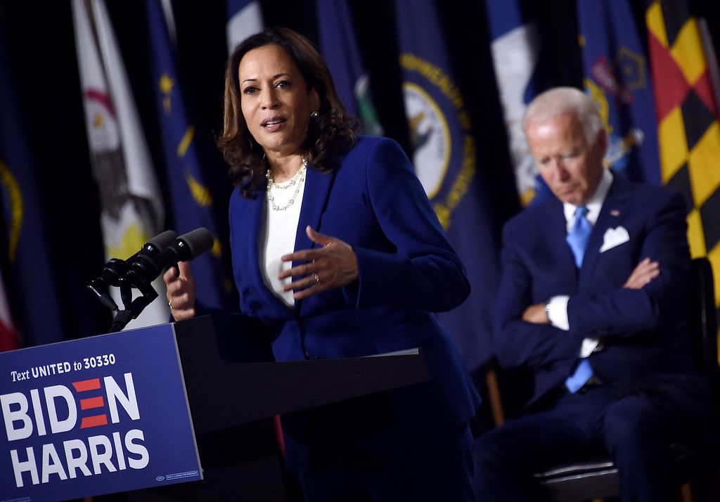 Democratic presidential nominee and former US Vice President Joe Biden listen to his vice presidential running mate, US Senator Kamala Harris, speak during their first press conference together in Wilmington, Delaware, on August 12, 2020