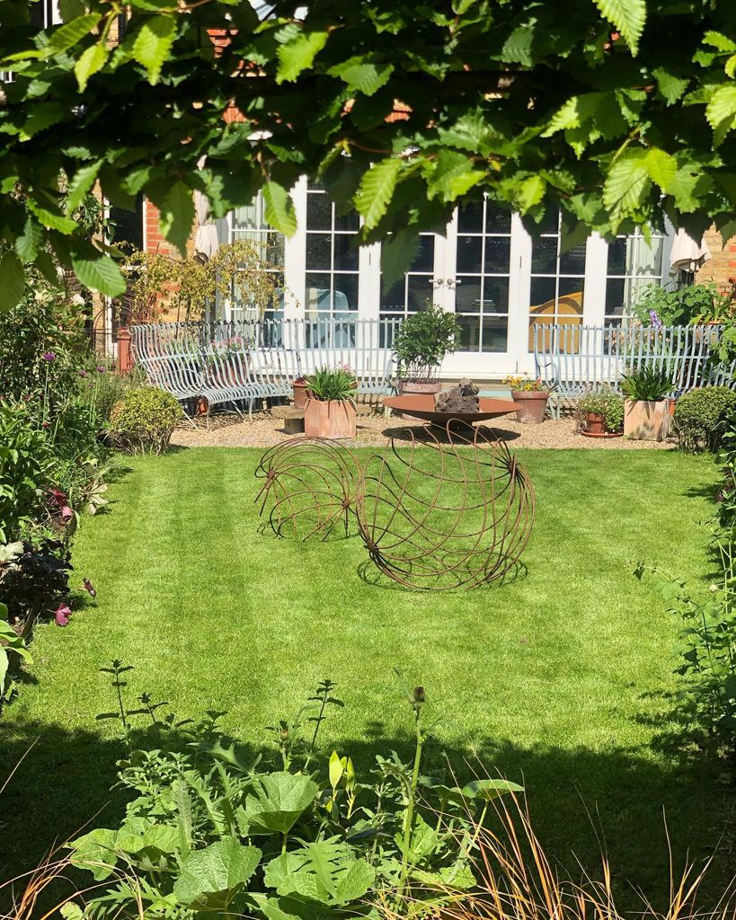 lawn with garden sculptures and fire pit 