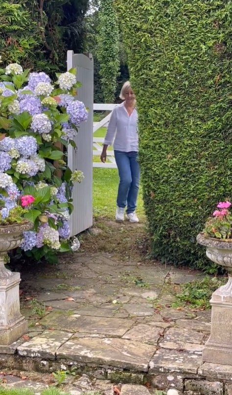 Shirlie walking through her garden