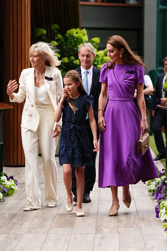Three women and a man walking 