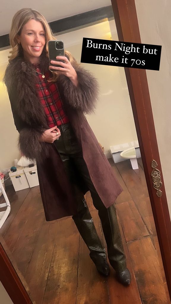 A mirror selfie of Carrie Johnson wearing a brown coat