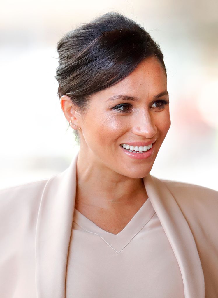 Meghan Markle, Duchess of Sussex visits The National Theatre on January 30, 2019 in London, England, wearing pastel pink.