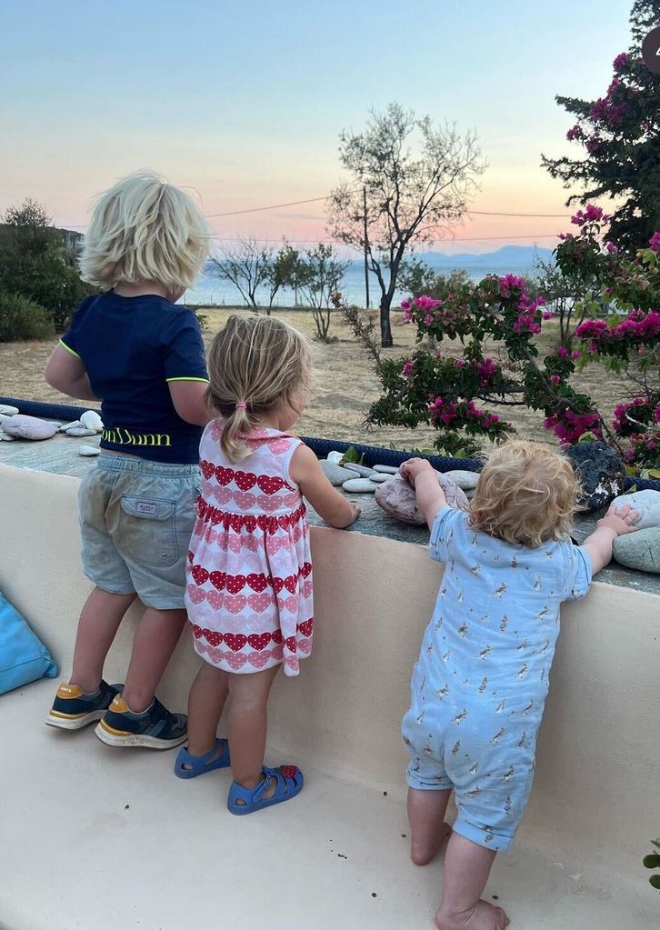 The sibling trio looked out a gorgeous Greek sunset