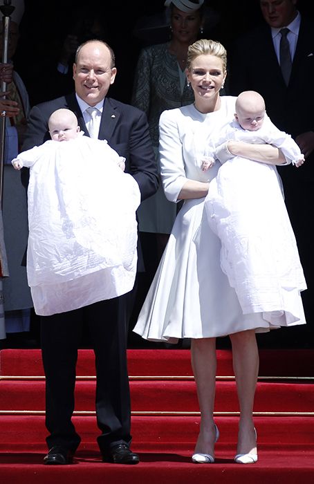 Princess Charlene and Prince Albert carry babies at their christening 