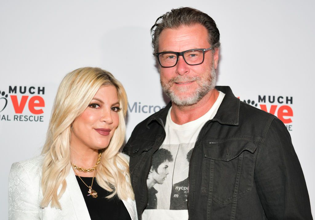 Dean McDermott and Tori Spelling pose together at a red carpet event. 