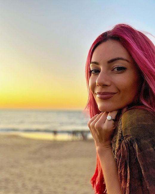 strictly dancer dianne buswell posing on beach at sunset