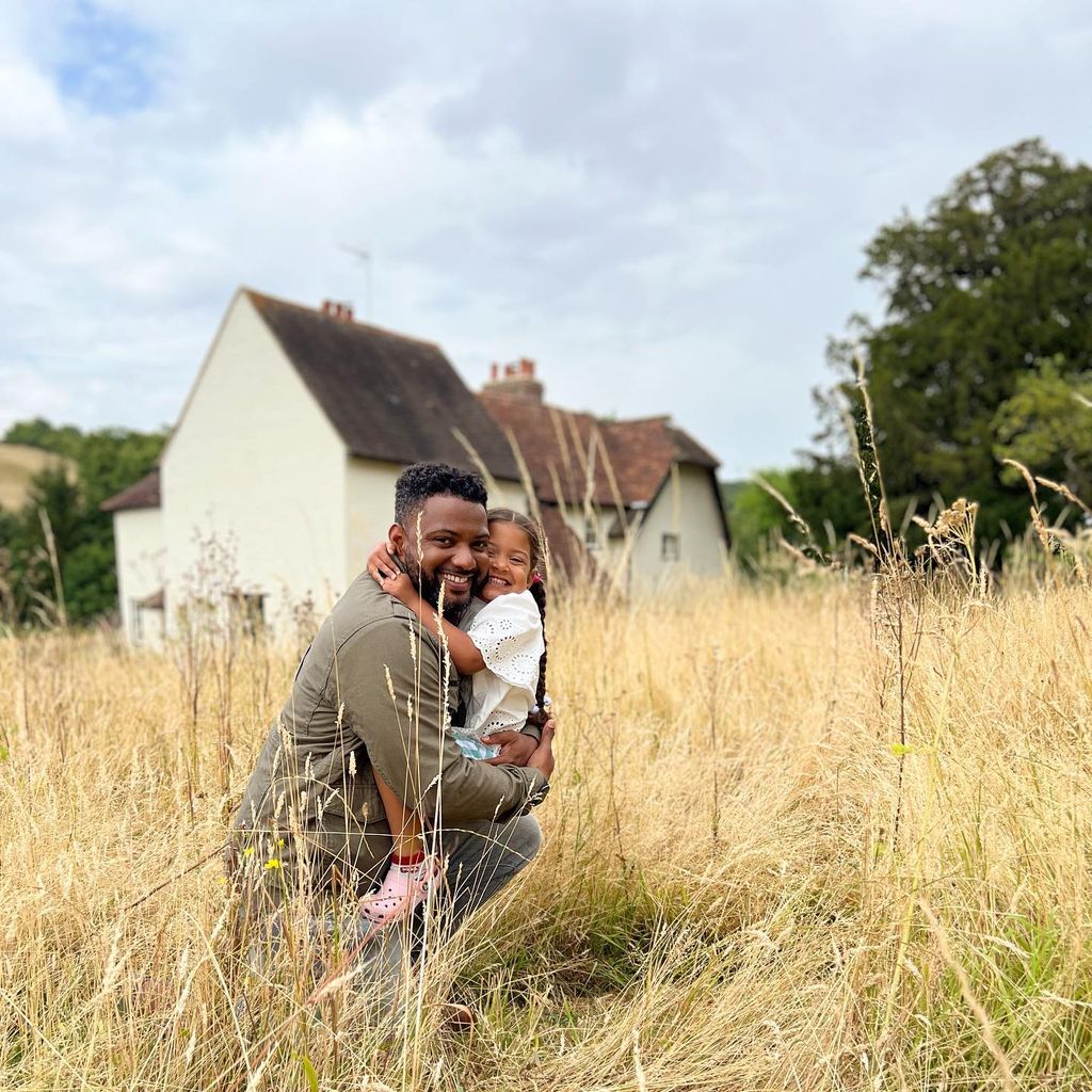 jb gill hugging daughter outside farmhouse