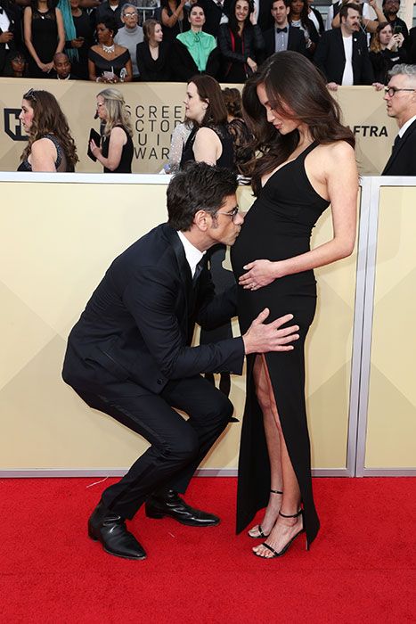 John Stamos kissing Caitlins baby bump
