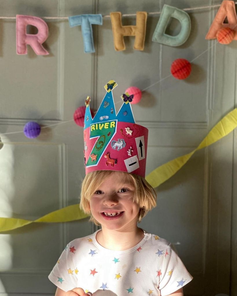 Jools Oliver's son River with a cardboard birthday hat