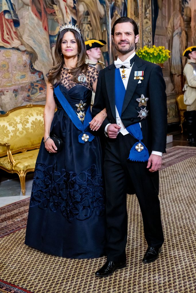 Princess Sofia in navy gown arriving at banquet with Prince Carl Philip