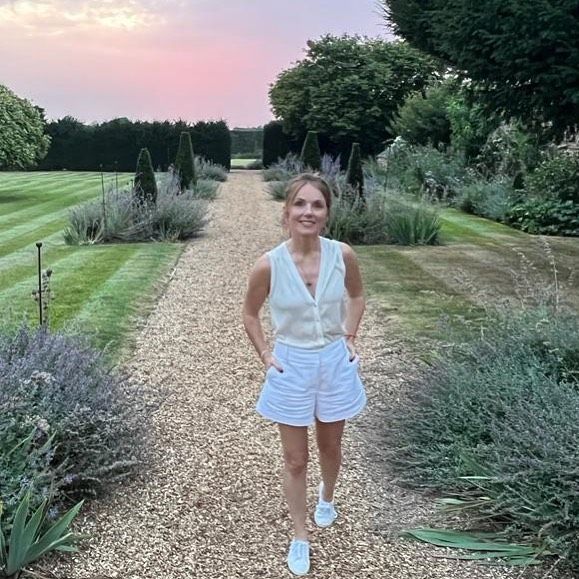 Geri Horner posing in white shorts at amazing country home