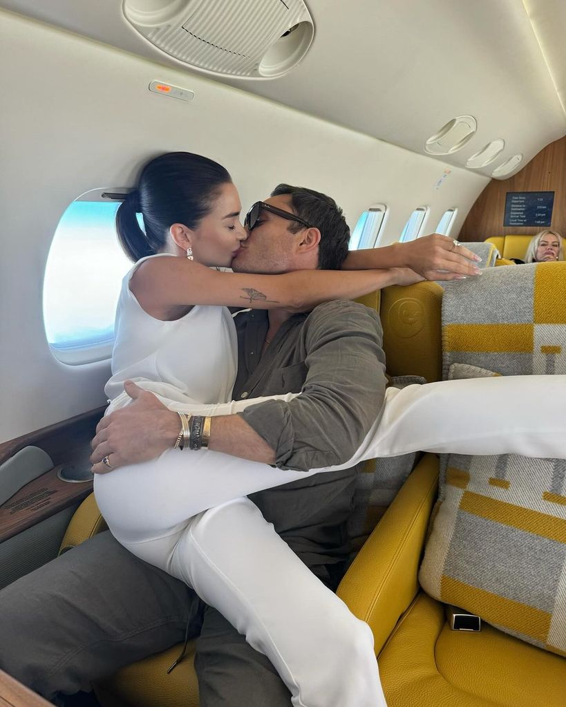 Amy Jackson sitting on Ed Westwick's lap on a plane