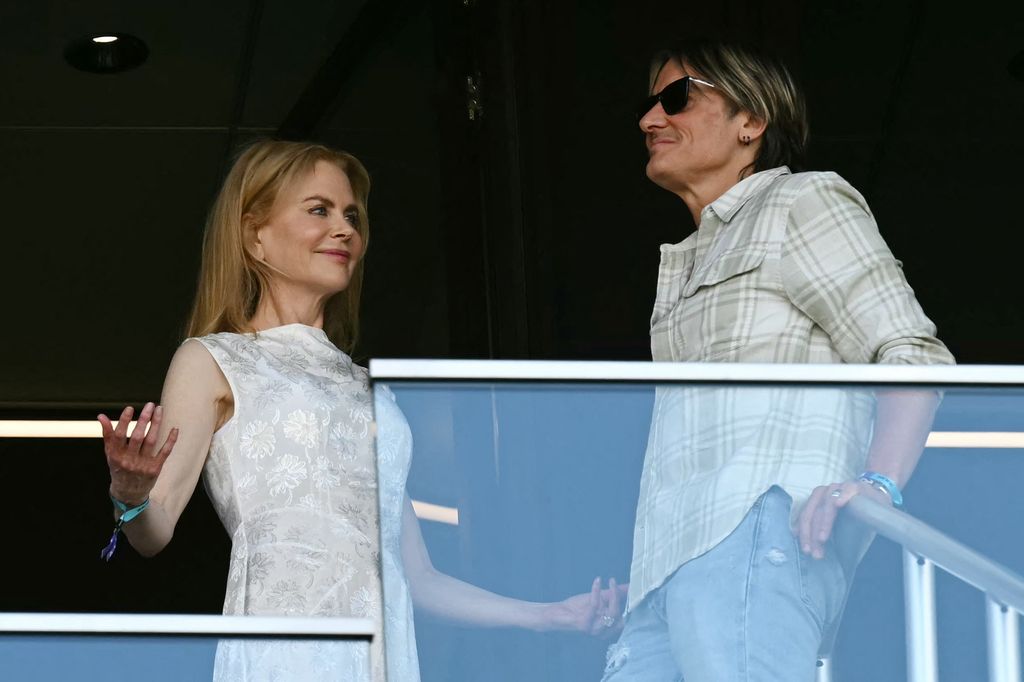keith urban and nicole kidman talking in box at soccer game