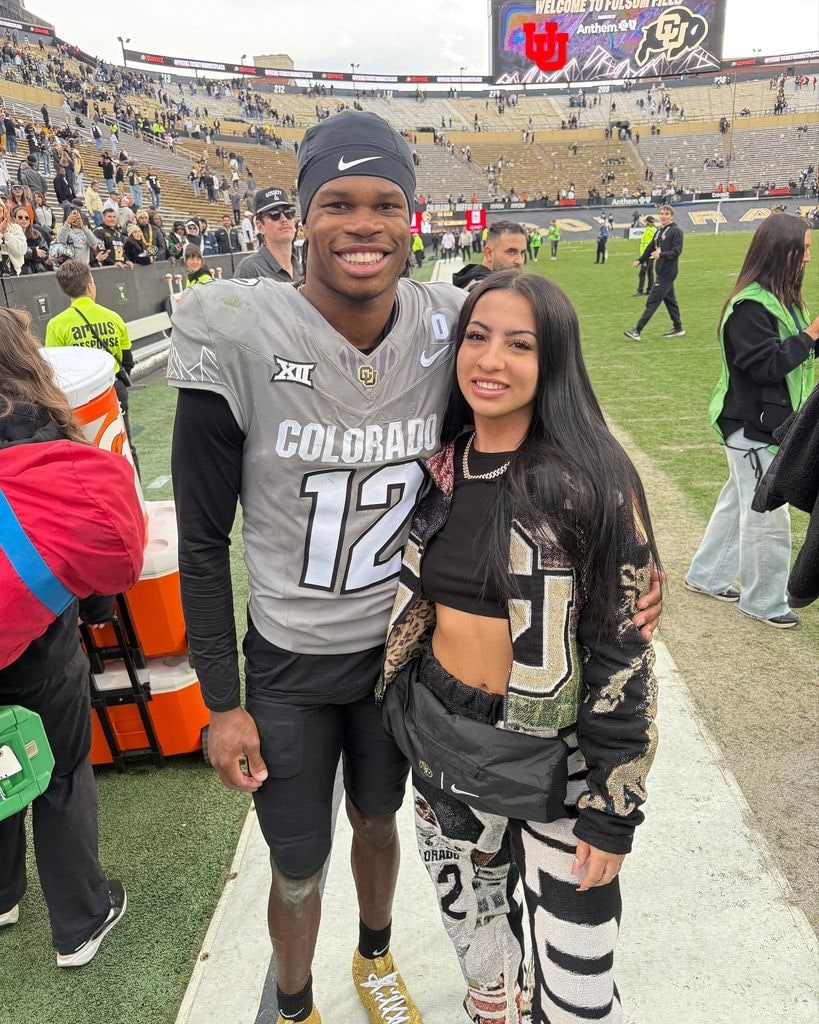 travis hunter and wife leanna lenee on football field