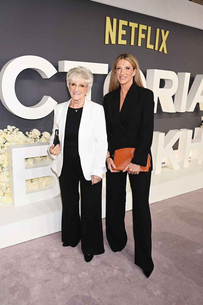 Sandra Beckham in black trousers and cream blazer beside joanne beckham in all black