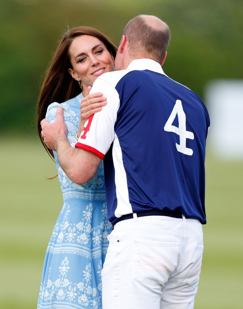 William and Kate embrace at charity polo match