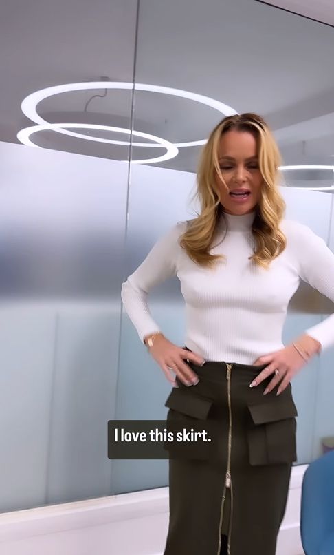 Amanda Holden in a white jumper and suede skirt