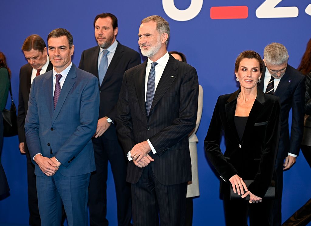 Queen Letizia in black suit next to felipe and others