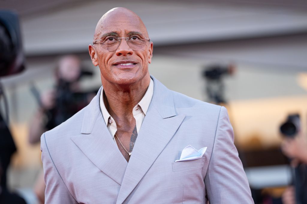 Dwayne Johnson smart in suit and glasses at Venice Film Festival