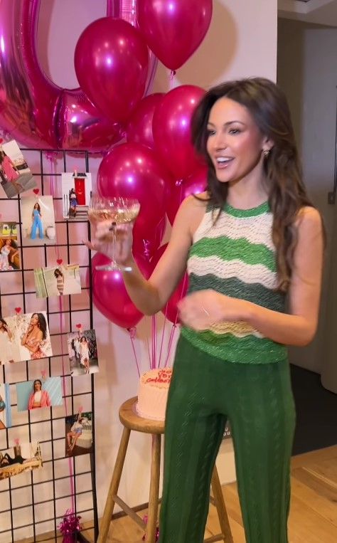 Michelle Keegan wearing green at a surprise party celebrating her Very collection