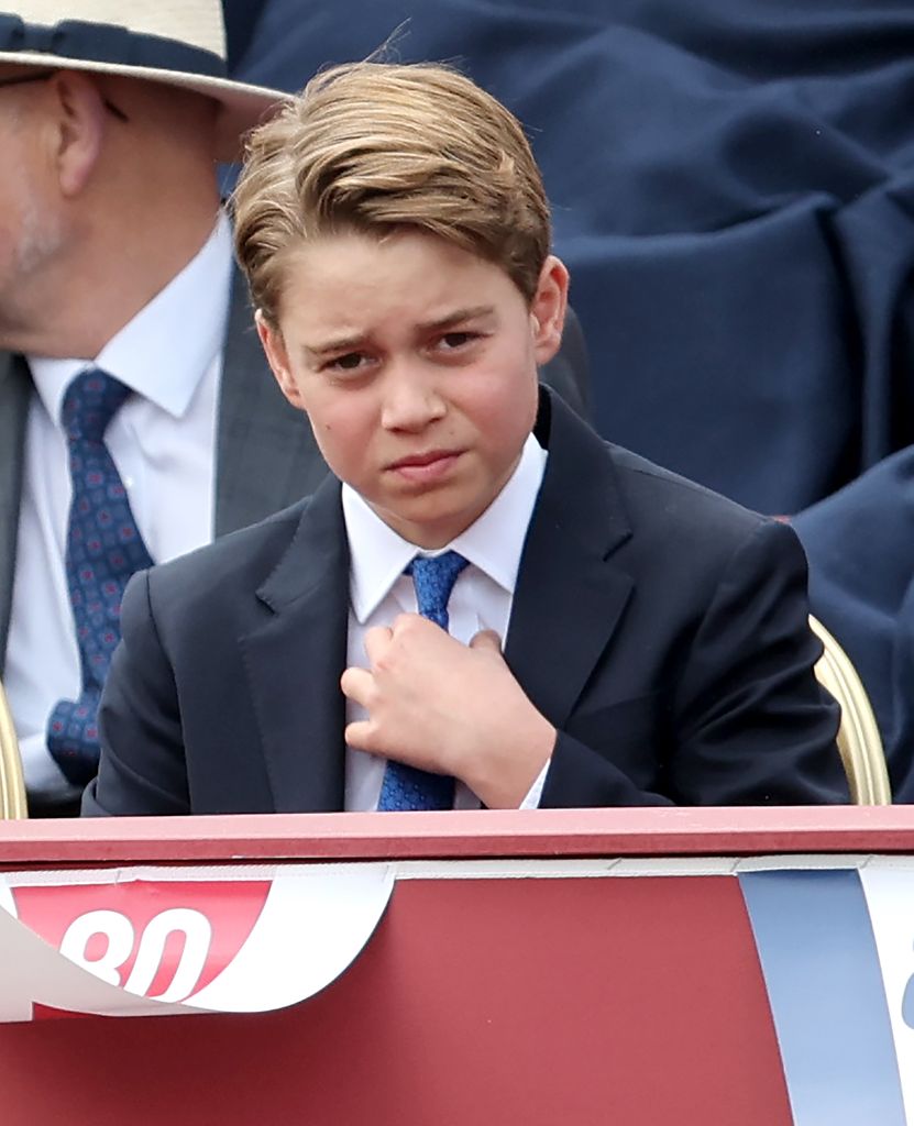 Prince George adjusting tie