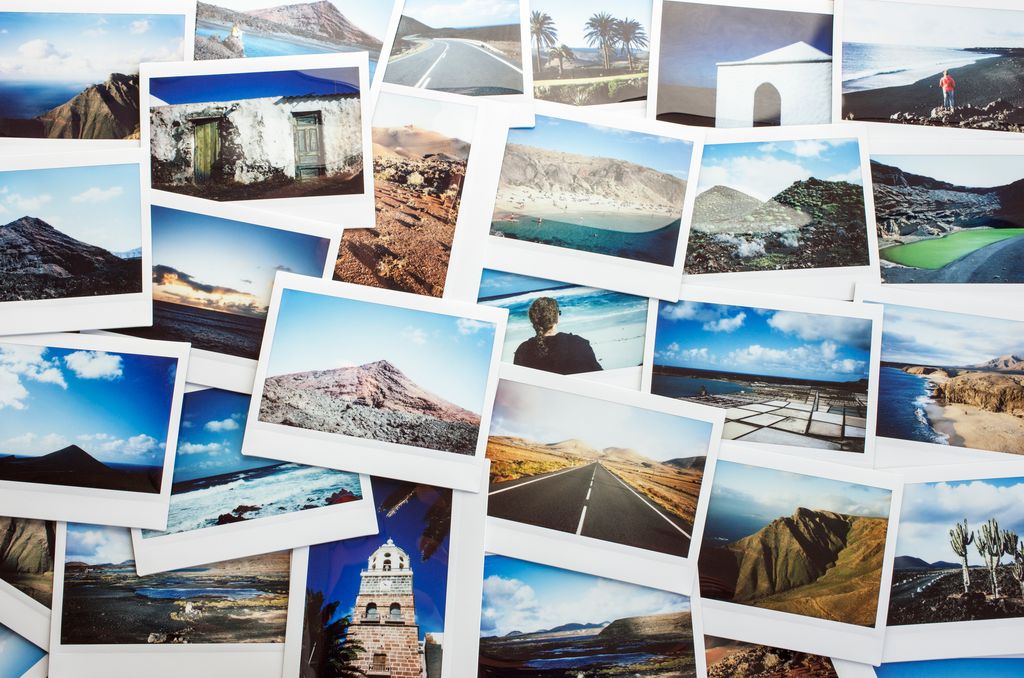 Spain, Lanzarote, variety of instant film travel photos laid out on a table