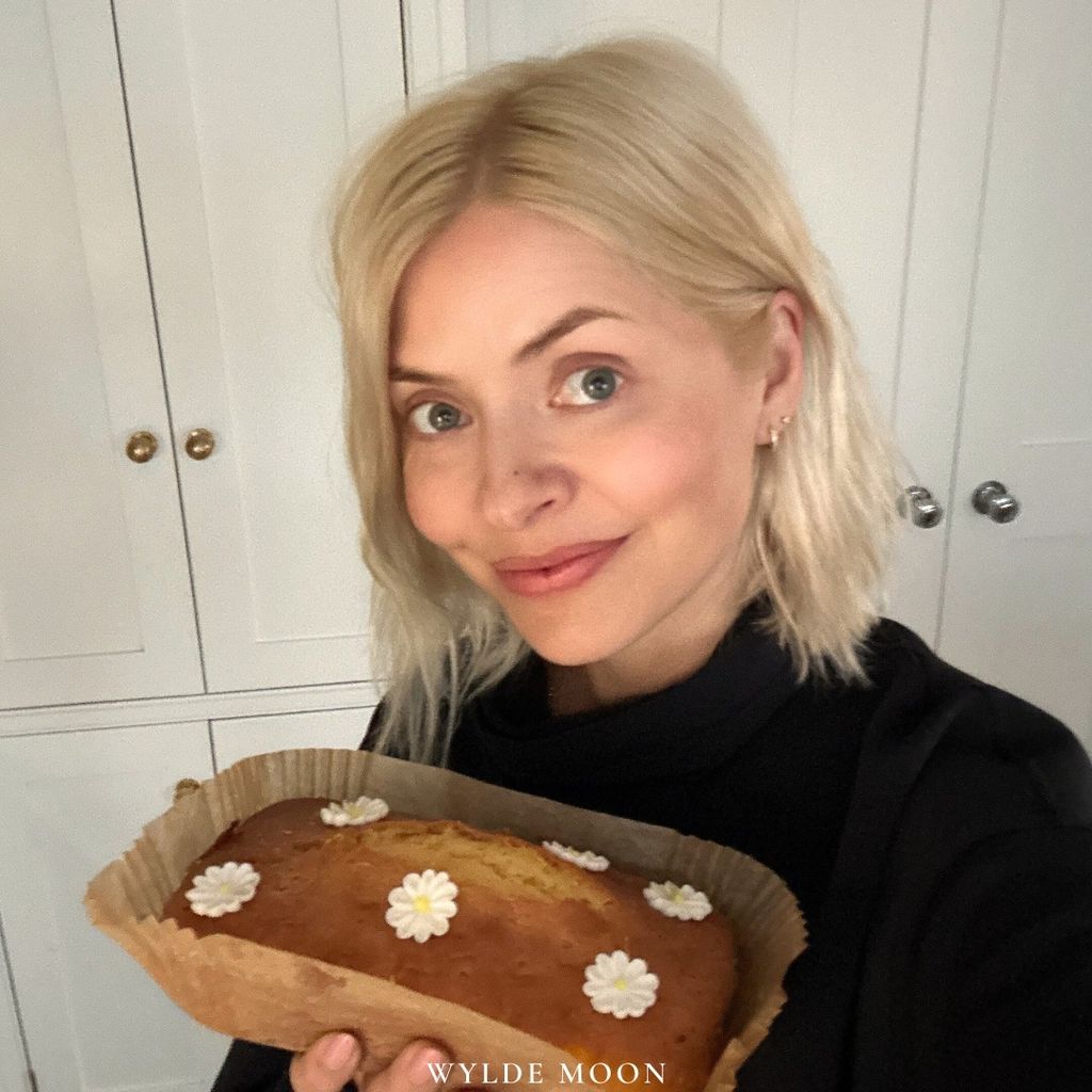 holly willoughby inside home holding a cake