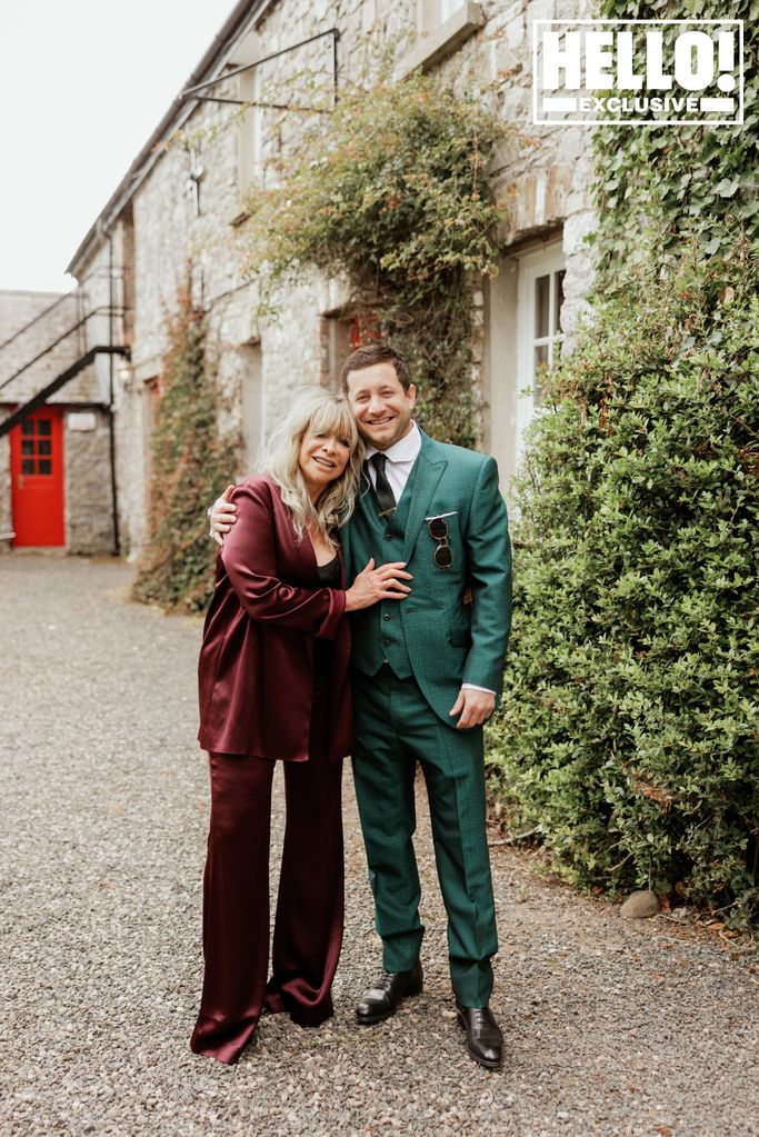 Jo Wood in a plum satin suit with Tyrone Wood on his wedding day