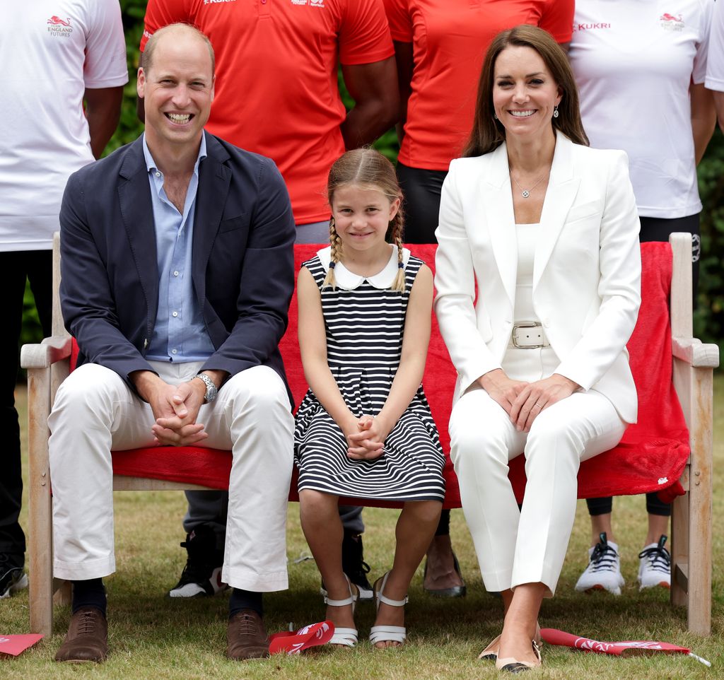  Prince William, Catherine, and Princess Charlotte of Cambridge pose sitting down