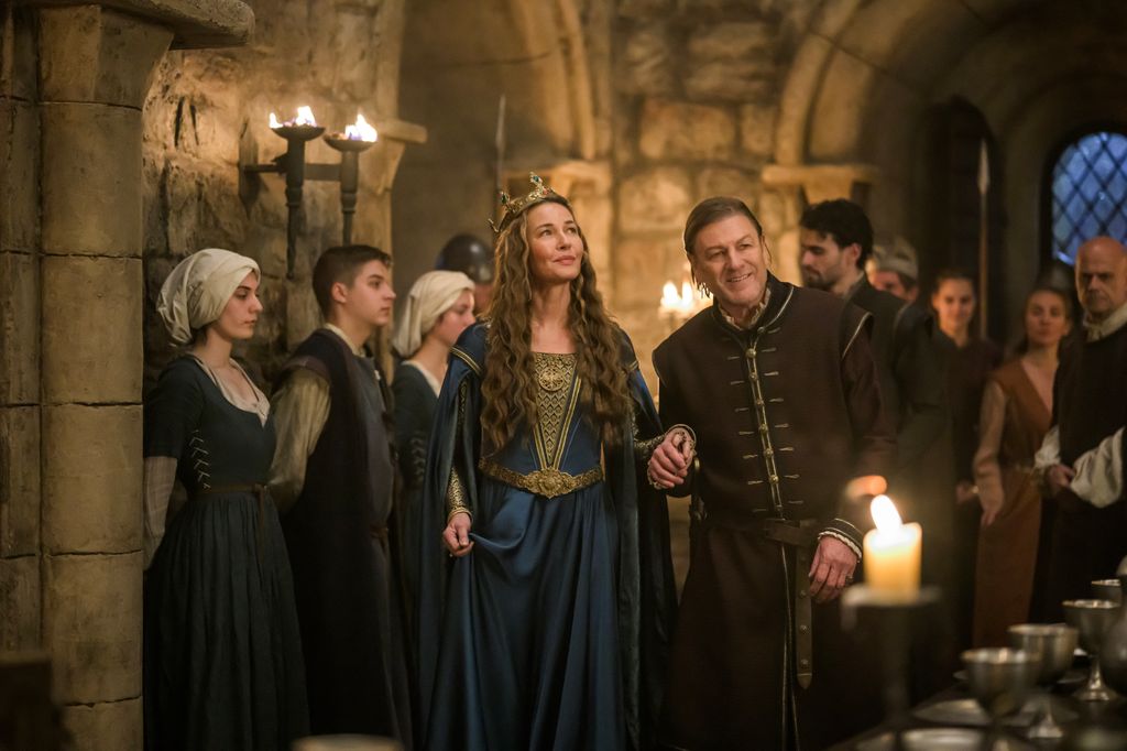 man and woman in medieval dress in dining hall