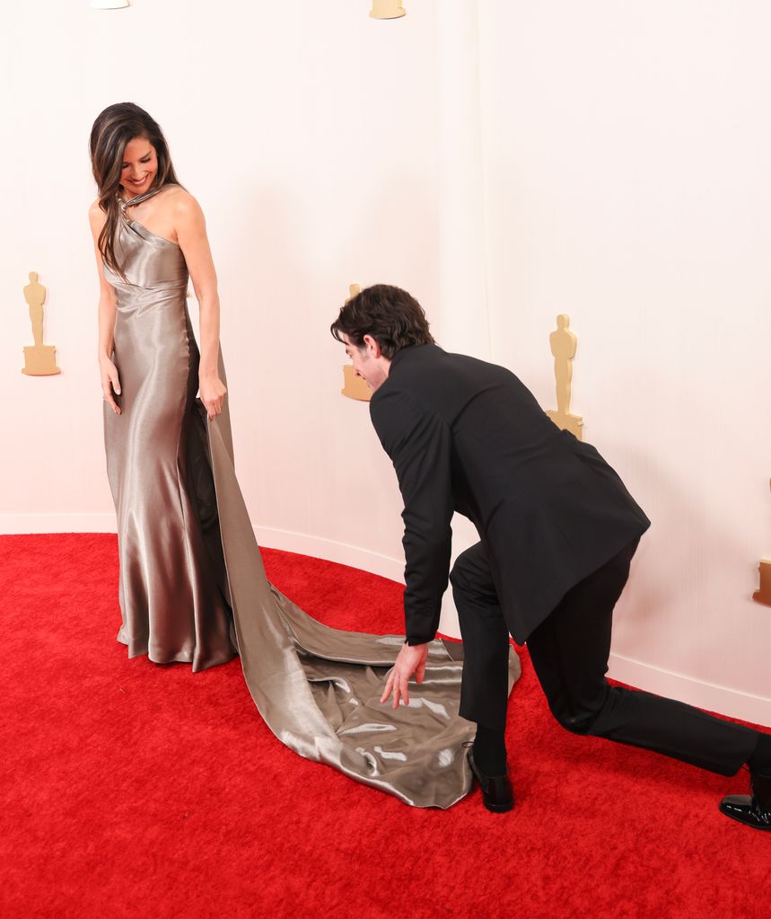 John was quick to fix Olivia's dress before they posed for photos