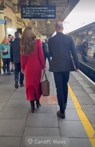 Kate Middleton in red coat and Prince William arriving at Cardiff station