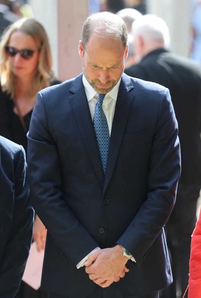 Britain's Prince William, Prince of Wales bows his head in respect as he attends a service at the 7/7 memorial in London's Hyde Park on July 7, 2025