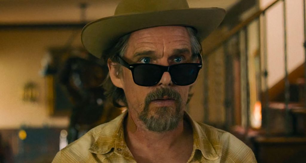 close up of man in hat and glasses