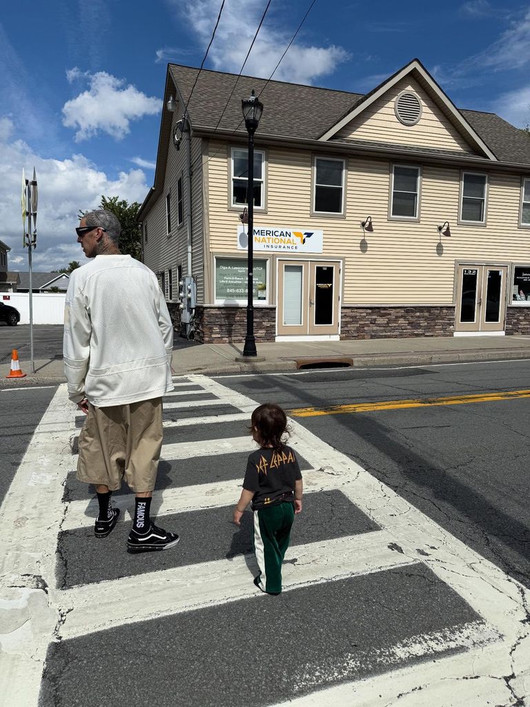 photo of travis barker and son rocky using a crosswalk