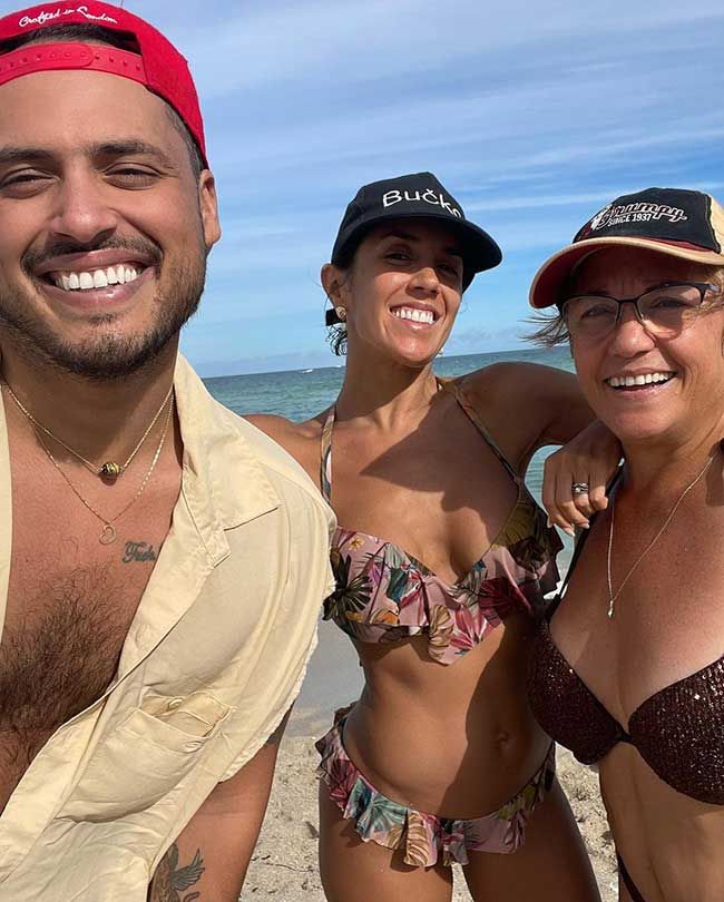 Janette on the beach with her brother and mum